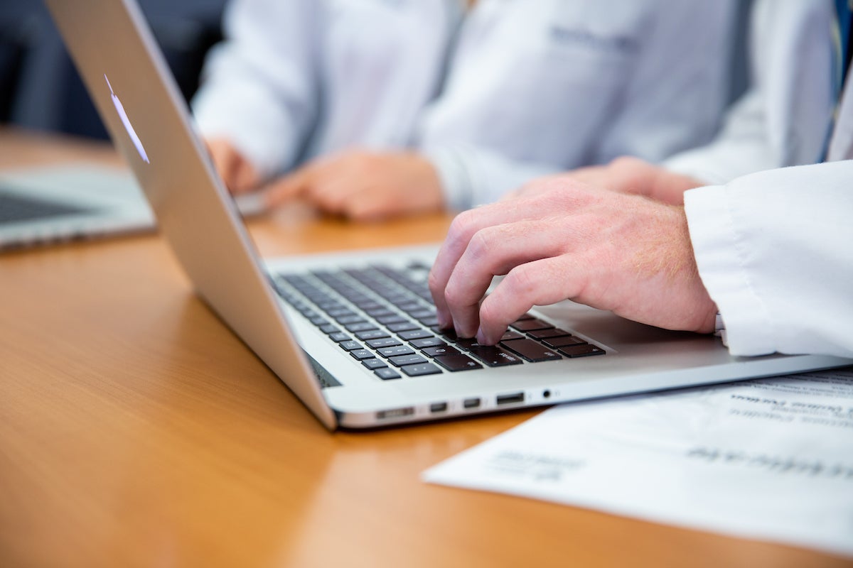 Student typing on a laptop.