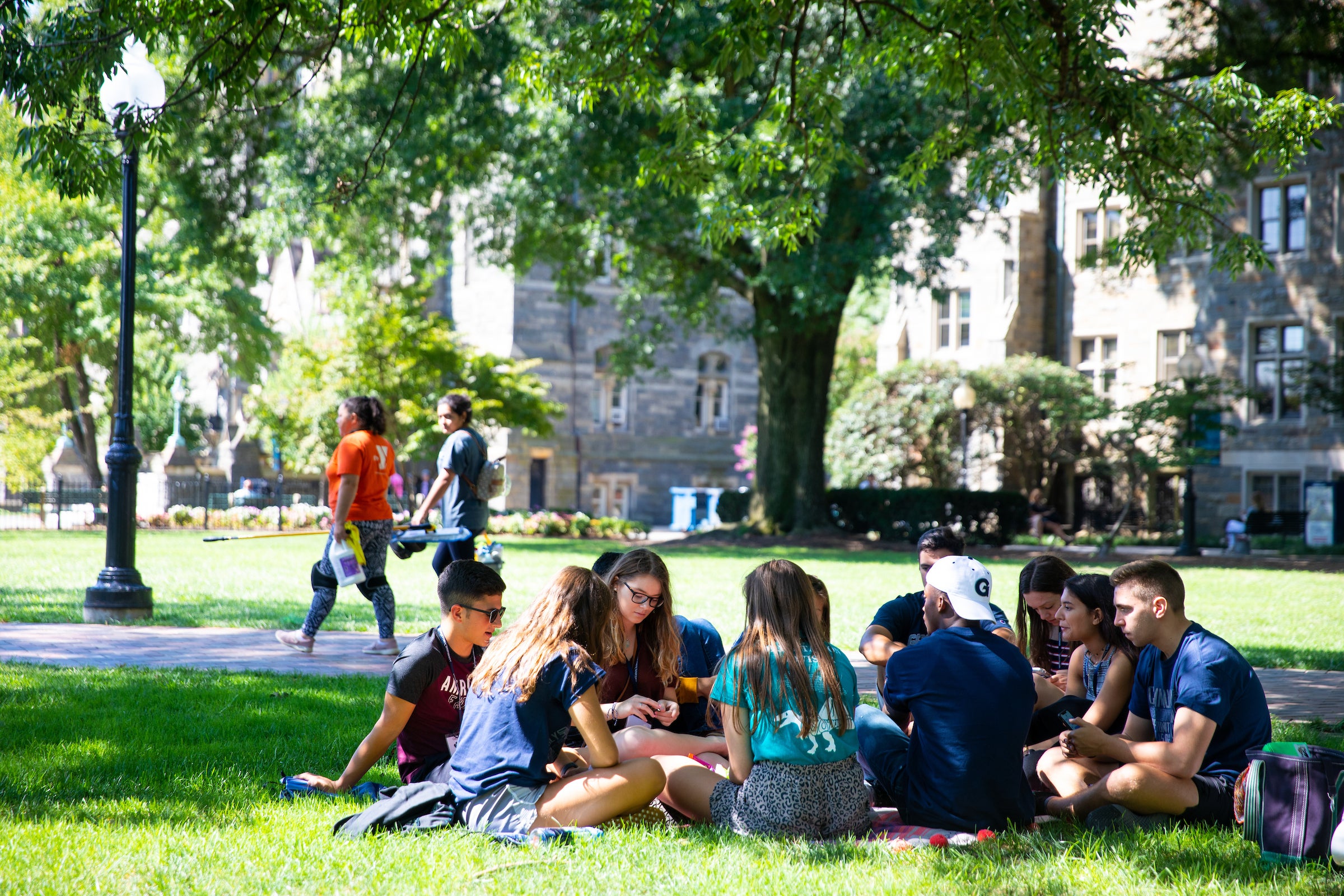 Group of students sitting in the grass at Healy Lawn.